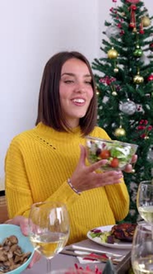 Friends Gather Around Table at Christmas Dinner