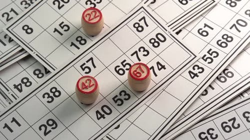 Lotto cards with numbers board game with wooden barrels rotating background side view. Bingo games