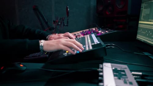 Close Up the Recording Room Dark with Neon Lighting in the Studio the Sound Engineer Works with the