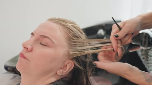 Woman Getting Hair Treated in Beauty Salon