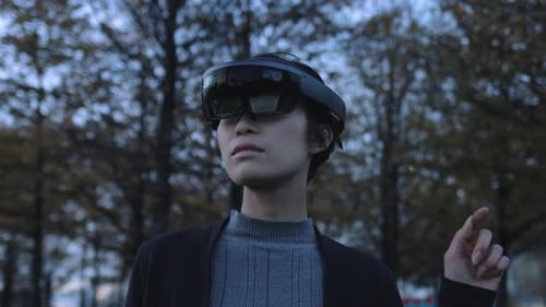 Asian female Using Virtual Reality in park