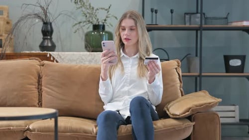 Online Banking Failure for Young Woman while Sitting on Sofa at Home