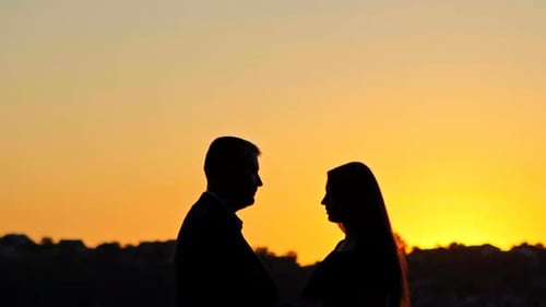 Silhouette Lovers Couple on Sunset Dusk Sky Background