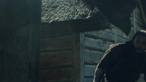 Man with Axe Outside Wooden Building