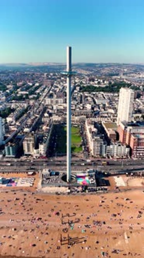 Vertical 4k drone video approaching Brighton's i360 observation tower from the sea. The beautiful so