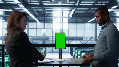 Programmers in Data Center Using Mockup Tablet Observing Equipment Analytics