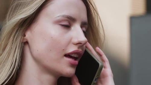 Blonde Woman Chatting on a Cellphone Close Up