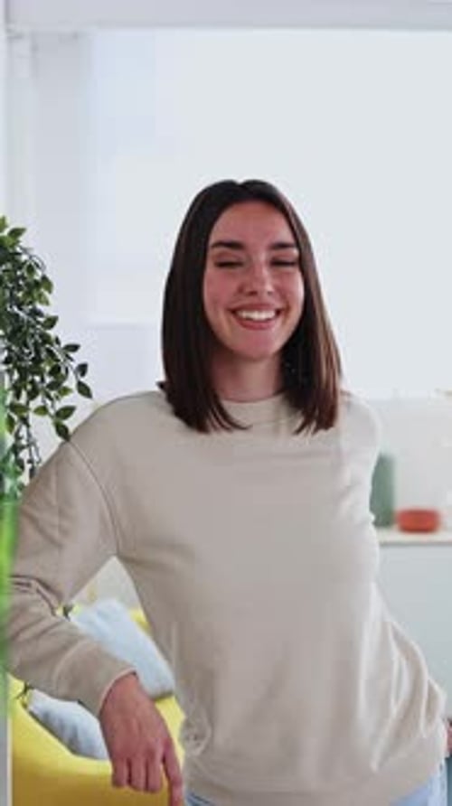 Smiling Brunette Woman in Comfortable Indoor Setting