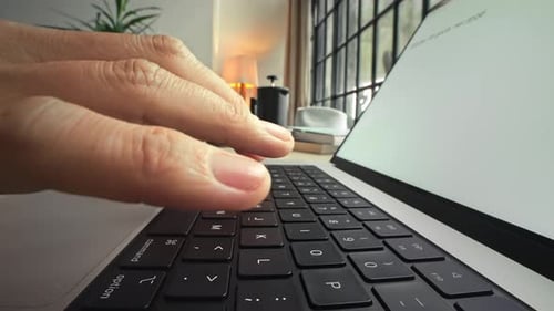 Hands of Woman Typing on Keyboard of Laptop Computer and Working in Home Office