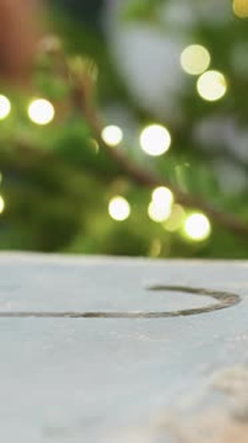 Finger Drawing a Heart Shape on Wet Surface