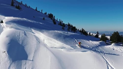 Professional Skier Jumping on Snowy Mountain Slope