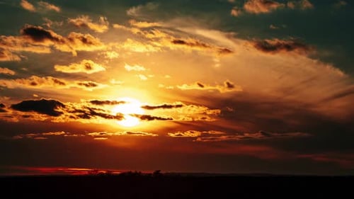 Dramatic Sunset with Golden Light and Dark Clouds