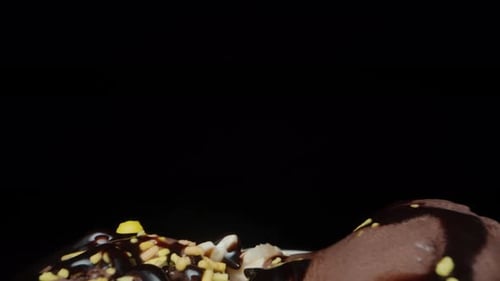 A glass with balls of chocolate ice cream and sugar sprinkles, I take a little spoon. Dolly slider,