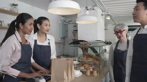 Entrepreneur and team are working at bakery and coffee shop.