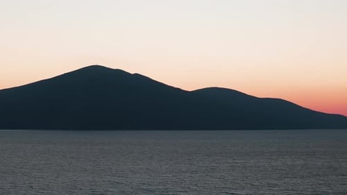 Dark mountain silhouette during sunset golden hour near Adriatic sea