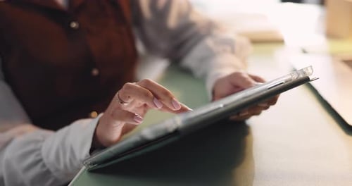 Woman Uses Tablet at Desk in Home Office