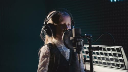 Young Girl Rehearses Singing in Studio