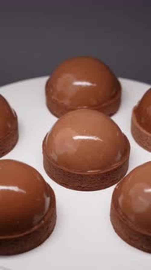 Shiny Chocolate Desserts on a White Surface