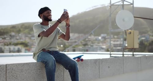 Young Adult on Rooftop with Smartphone