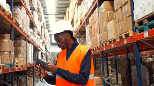 Warehouse Worker Scanning Packages with Barcode Scanner