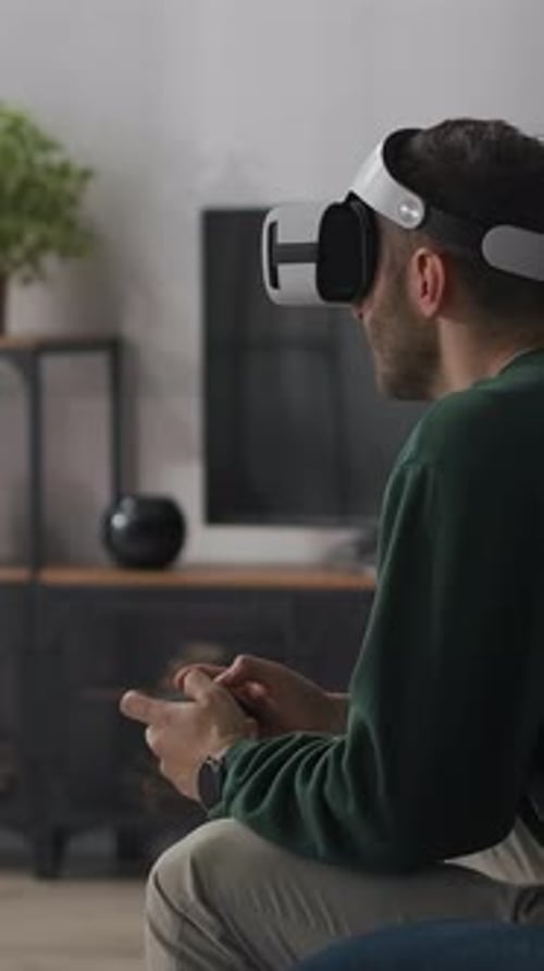 Man Experiencing Virtual Reality with Headset Indoors