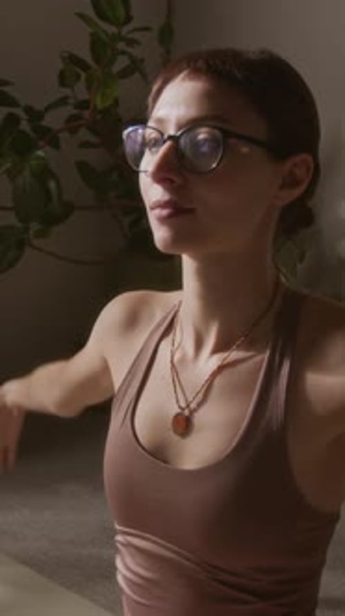Vertical of Girl Performing Seated Torso Twist during Yoga Practice