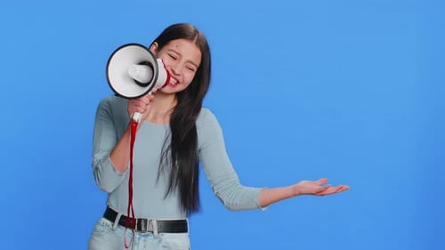 Smiling Woman Shouting into Megaphone on Blue Background