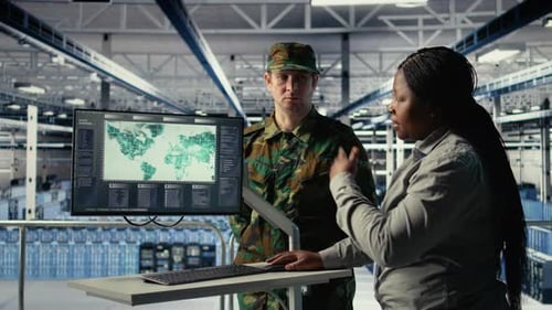 Adults Viewing World Map on Computer in Factory