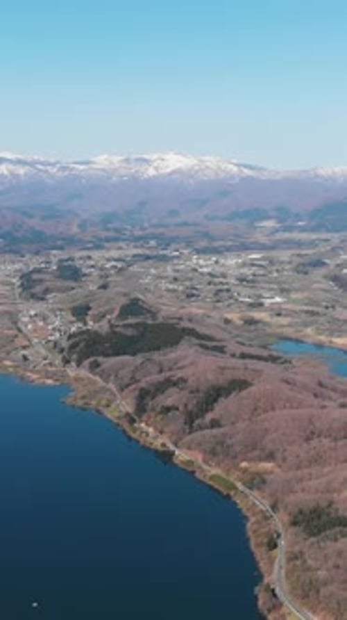 Vertical Aerial establishing fly Mount Zao crater lake Landscape in Japan, skyline background
