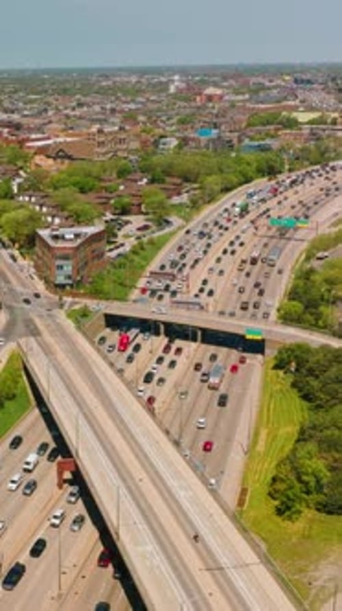 Wide multiple-lane roads with numerous cars. Automobiles driving in both directions
