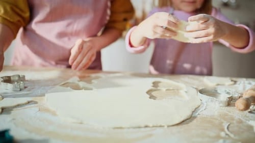 Mother and Daughter Baking Cookies Together at Home