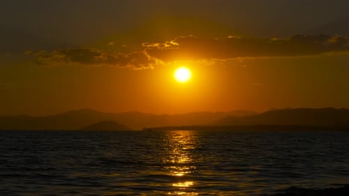 Orange Nightfall Sun at Tranquil Cliff