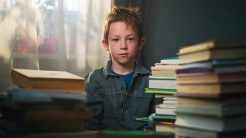 Tired Child Surrounded by Books at Desk