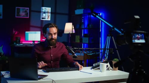 Man Vlogging About Gaming Equipment in Studio