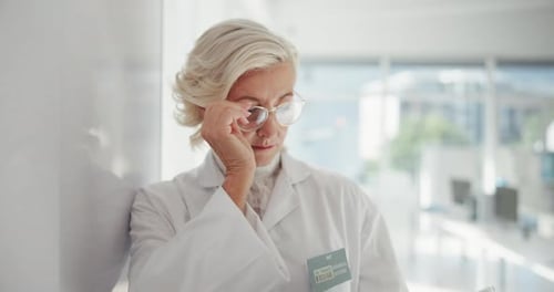 Mature Doctor Using Tablet in Modern Clinic