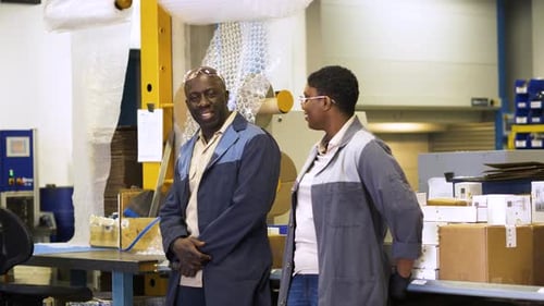 Smiling Workers Talking In Manufacturing Plant Slow Motion