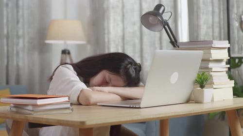 Tired Asian Teenager Sleep On The Table At Home After Doing Home Work