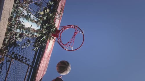 Upward View Basketball Ball Hits the Basket The Player Successfully Throws the Ball Into the Hoop