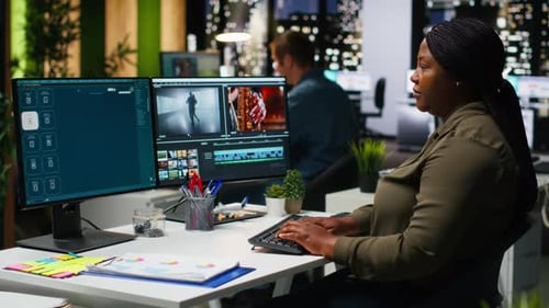 Woman Editing Video on Computer in Office at Night