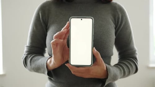 Woman Holding Smartphone With White Screen in Portrait