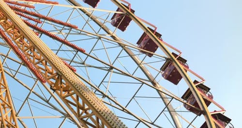 Colorful Ferris Wheel Structure Against Blue Sky