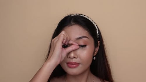 Glamorous Woman Applying Eyelashes for Beauty