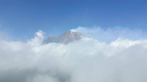 Aerial View Of Active Merapi Volcano Above The Clouds In The Blue Sky Indonesia