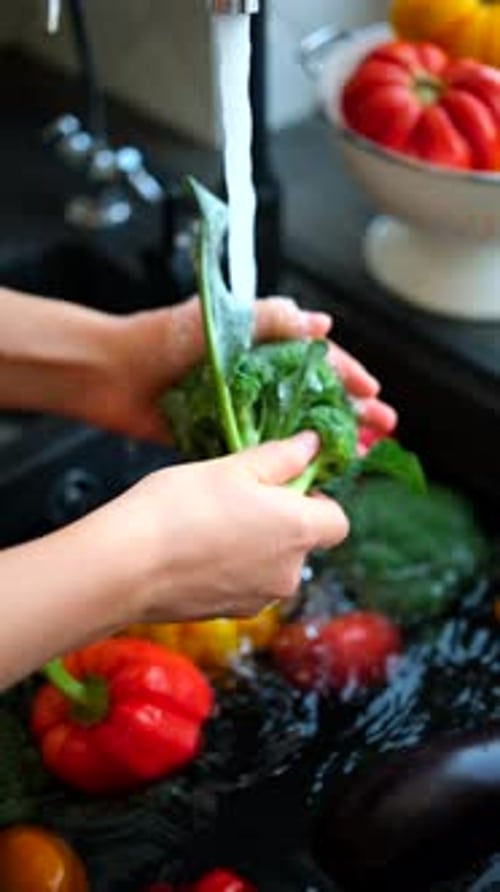 Washing Fresh Vegetables in a Kitchen Sink
