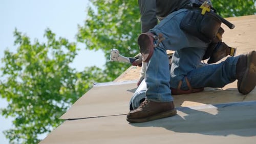 Roofer Installing Roofing Material on a Sunny Day