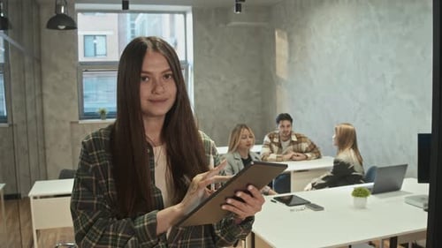Woman Using Tablet in Modern Urban Office