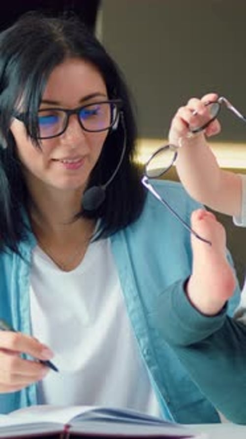 Young Woman Works at Home with Her Baby