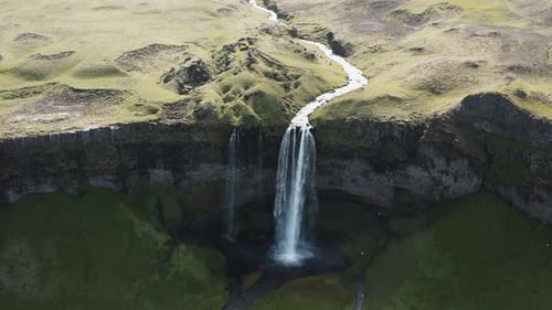 Breathtaking Aerial View of Waterfall and Green Landscape