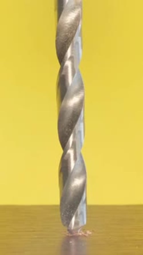 Drill Bit Drilling Downward in a Close Up Shot