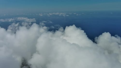Flying Through White Clouds Over Sea